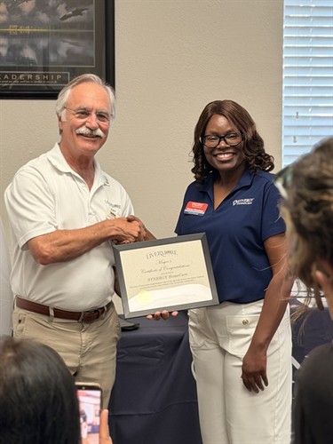 Founder, Vivian Mendoza Receiving Award from Mayor Marchand