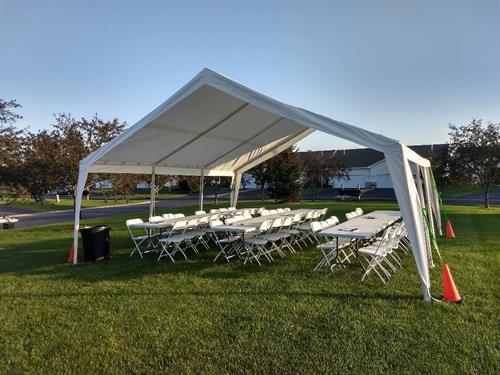 20X20 TENT, TABLES AND CHAIRS ON GRASS