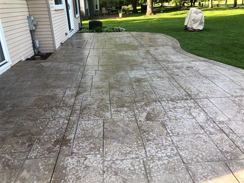 This is a stamped concrete patio with over application of sealer, before we removed the sealer usibg wet abrasive blasting