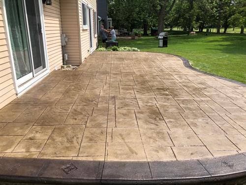 This a stamped concrete patio after sealer removal usunf wet abrasive blasting, we then stained the border and applied 2 coats of sealer
