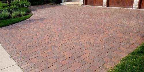 A paver driveway before cleaning