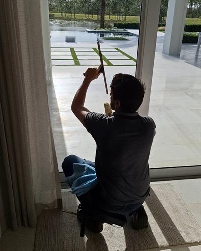 Alex cleaning interior windows in Martin County.