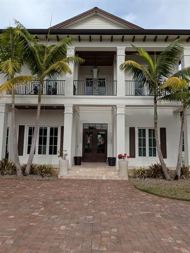 A large multi-story home having it's windows washed in Palm City.