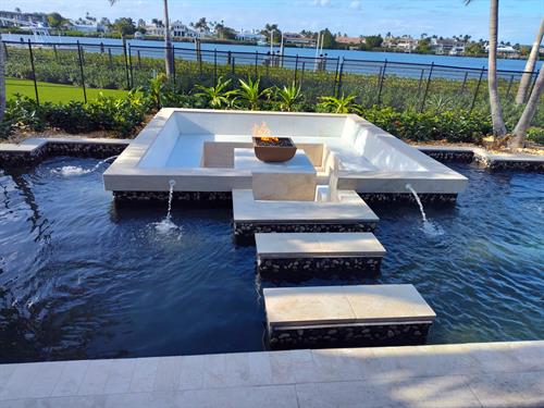 Gas Fire feature Backyard Seating within Koi Pond