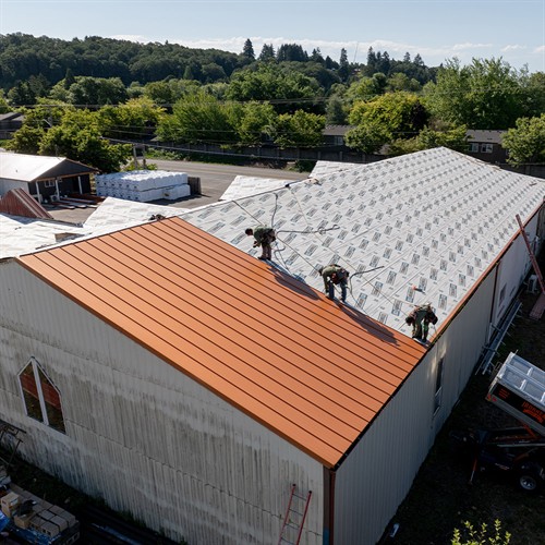 One of our crew delivering a full metal replacement on a commercial job, built for durability and done right the first time.
