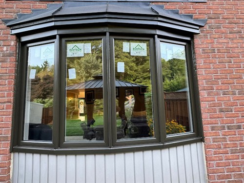 Custom black bay window installed by EcoTech Windows & Doors, adding natural light, interior space and modern curb appeal to an Ontario home.
