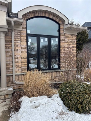 Custom black arched replacement window from EcoTech Windows & Doors, designed for lasting performance and year-round energy efficiency in Ontario.