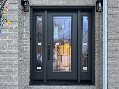 Elegant black double front entry doors with glass panels, installed by EcoTech Windows & Doors to enhance security, energy efficiency and home value.