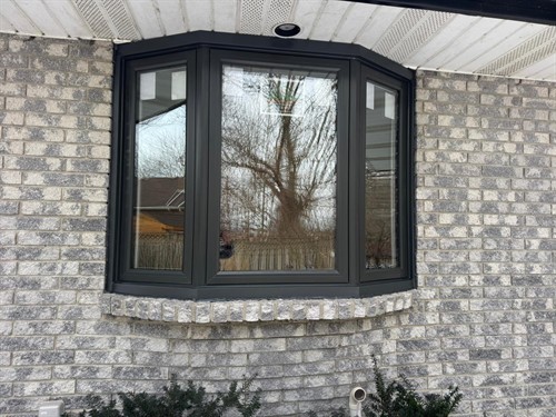 Black energy-efficient bay window professionally installed by EcoTech Windows & Doors to provide better insulation, natural light and modern curb appeal.