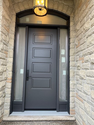 Custom grey front entry door installed by EcoTech Windows & Doors, combining energy efficiency, durability and modern curb appeal.
