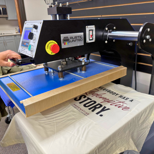 Customer Pressing a Custom T-Shirt in Our Free Heat Press Room