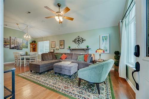 Enter the sunny great room through coded entry to warm colors & comfortable furniture. High ceilings, flatscreen, entertainment center & dining for 6