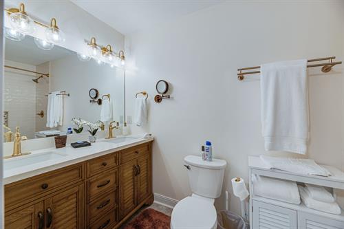 Master en suite has a double marble vanity, gold fixtures and large shower/tub combo