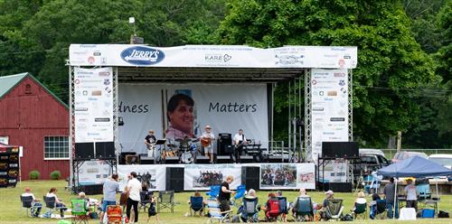 Stage with corporate sponsors at 1st Annual KARE Fest