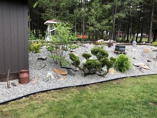 After Landscape Garden bed project lowering maintenance and a fresh look