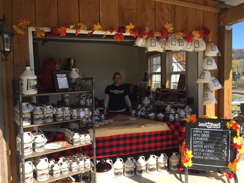 Rachel Courtney standing the the sugar shack at a fall event.
