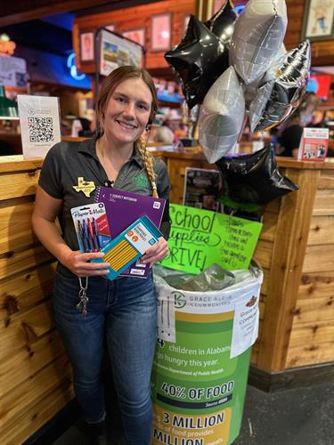 Our Service Manager Allegra helping fill our school supply drive barrel from our partners at Grace Klein Community!