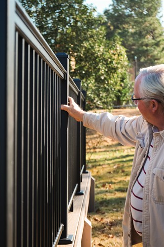 KEvin Cato inspecting handrail he recently installed.