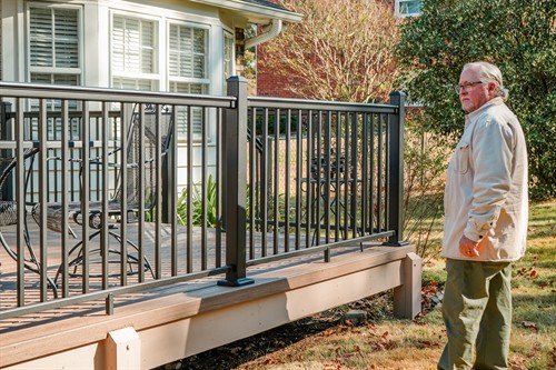 Kevin Cato inspecting a deck he recently built.