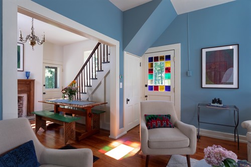 Bright, sun-filled living room with tall windows.