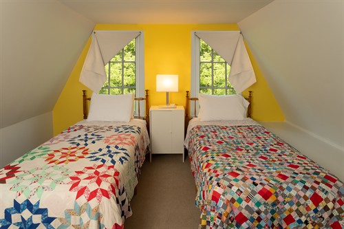 Summer kitchen bedroom loft has two XL twin beds and a sitting area. 