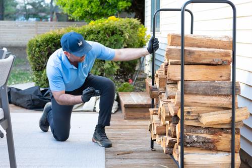 An Agile Pest technician inspects a home’s exterior for rodents in Monmouth County, NJ