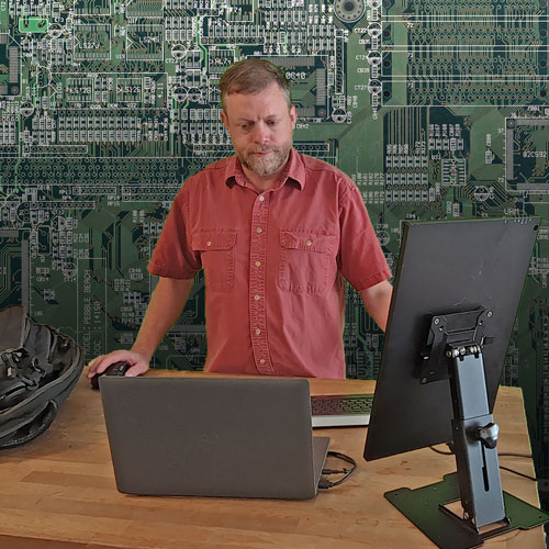 Jake Onami Agnew (the company founder and CEO) hard at work, using a portable office environment.