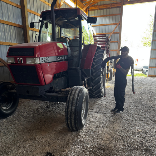 Nick replacing windshield on tractor