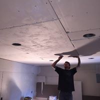 David working on hanging a ceiling. David working on hanging a ceiling.
