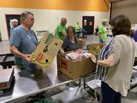 Assisting All Faith's Food Bank with food sorting