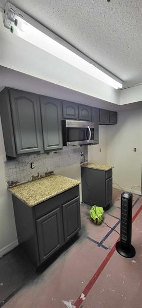 These cabinets were sanded and painted a beautiful dark gray color. 