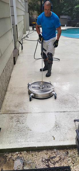 Here we are power washing, repairing and painting a pool deck.