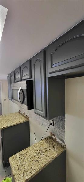 These cabinets were sanded and painted a beautiful dark gray color. 