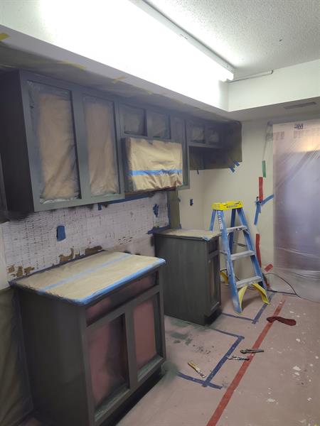 These cabinets were sanded and painted a beautiful dark gray color. 