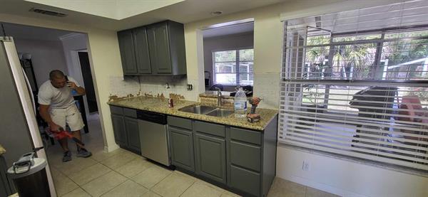 These cabinets were sanded and painted a beautiful dark gray color. 