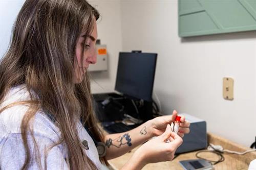 Medical assistant performing diagnostic tests onsite