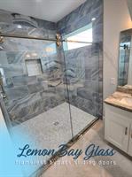 Frameless glass shower showcasing craftsmanship and clarity, by Lemon Bay Glass. Frameless glass shower showcasing craftsmanship and clarity, by Lemon Bay Glass.