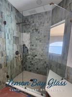Custom angular shower enclosure designed and installed by Lemon Bay Glass for a custom home builder. Custom angular shower enclosure designed and installed by Lemon Bay Glass for a custom home builder.