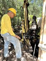 Helical pier installation on a homes foundation.