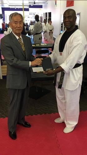 2017 Supreme Grandmaster Bok Man Kim Presents Master El with special award at weapons seminar at UMAM.