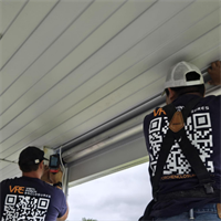 Vinyl & Shade Team Installing Motorized screening panel