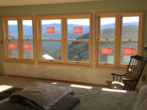 After the homeowner removed a dangerous 3rd floor deck, we reframed this wall to change the doorway & side windows into spaces for 6 new windows to still enjoy these mountain views.