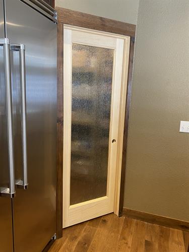 This new door into the pantry still lets in light from the kitchen.