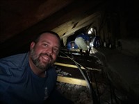 Goose and the crew working in an attic to restore cool temps to the house!