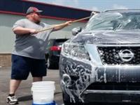 Chris Martin, General Manager, working hard washing cars.