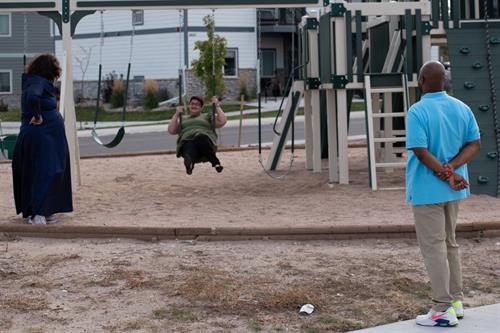 Essential Living Support participants building strength and confidence on the playground during a community outing in Cheyenne.