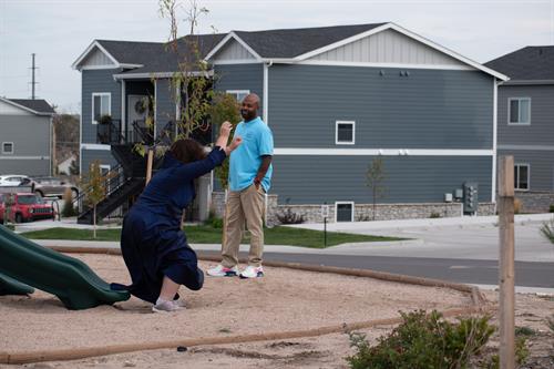 Clients and staff walking together in a safe neighborhood setting, practicing life skills and healthy outdoor activity.