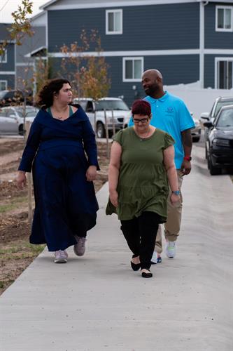 One-on-one support as a client and caregiver walk side by side, focusing on independence, mobility, and community inclusion.