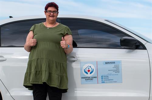 Essential Living Support team member standing by our vehicle, ready to provide reliable transportation and home based care.