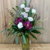 Flower arrangement with orchids and lisianthus going out for delivery